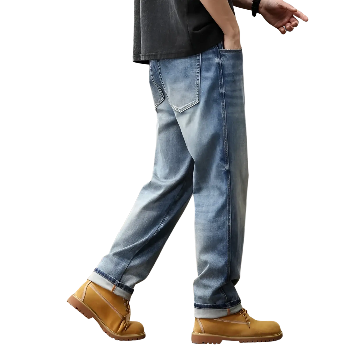 Baggy light blue denim jeans with a relaxed fit and rolled cuffs paired with tan work boots