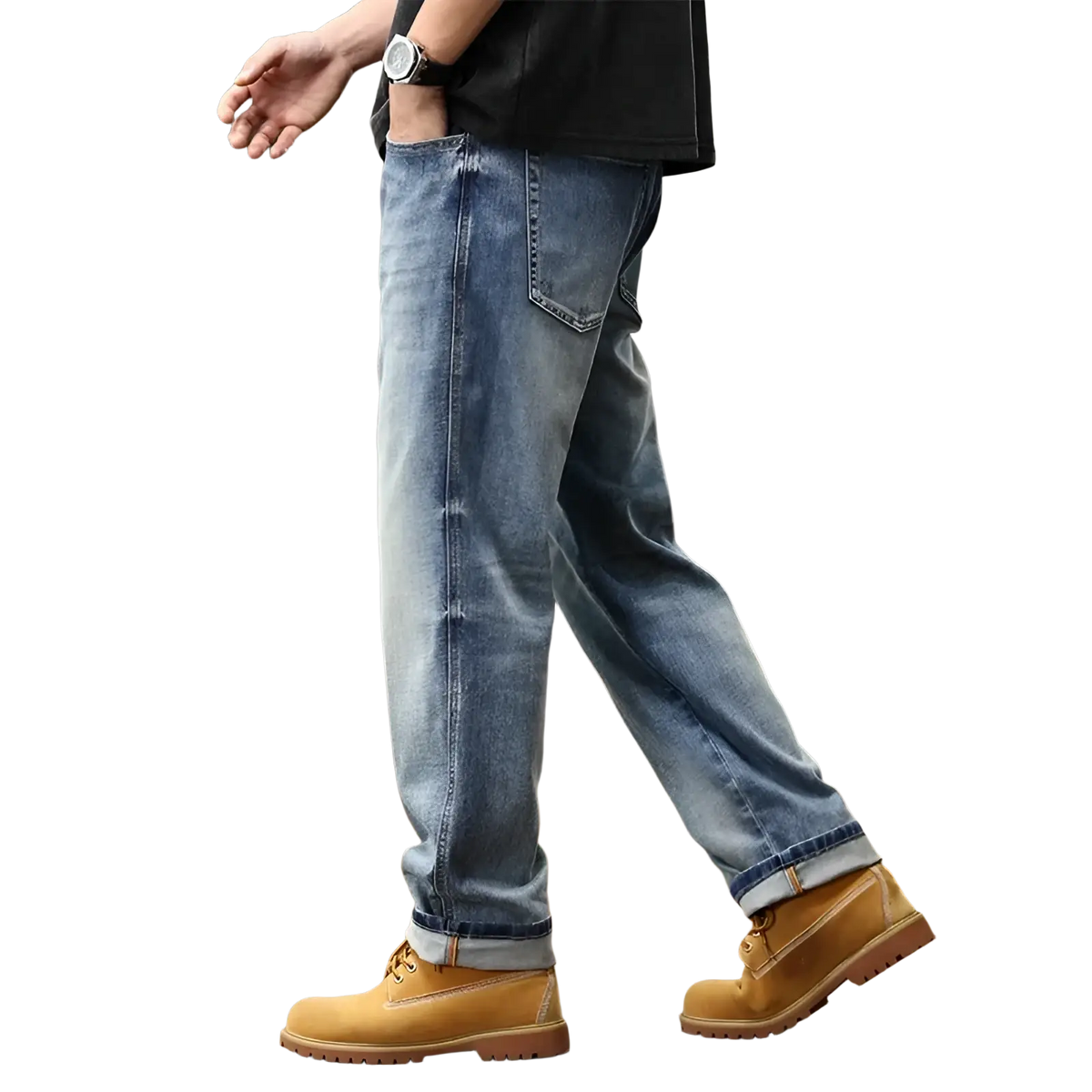 Baggy light blue denim jeans with a relaxed fit and rolled cuffs paired with tan work boots
