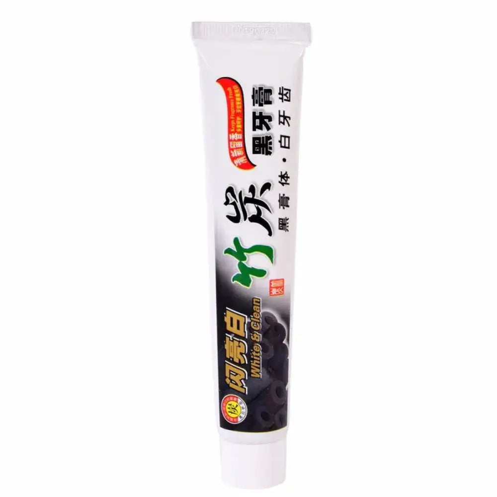 White tube of bamboo charcoal whitening toothpaste with black and green branding for deep stain removal