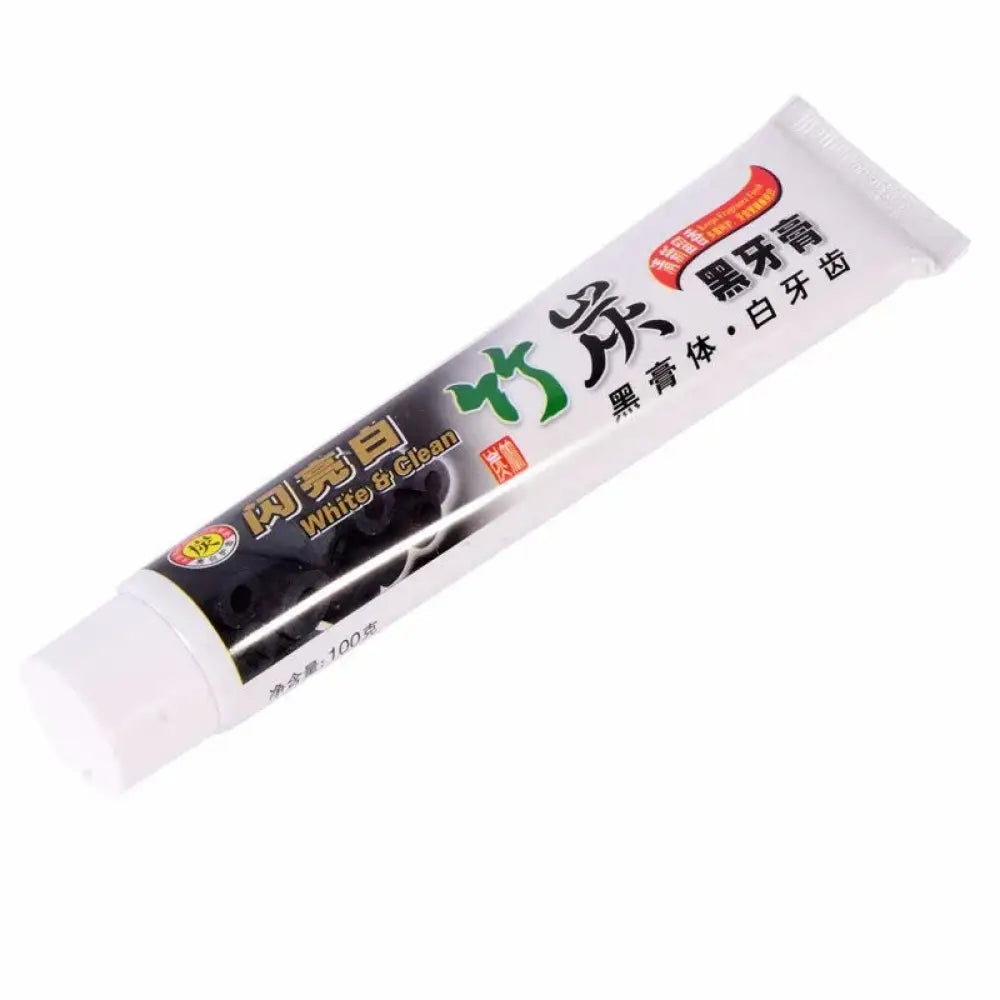 White tube of zhu jia brand bamboo charcoal whitening toothpaste for deep stain removal labeled black paste for white teeth