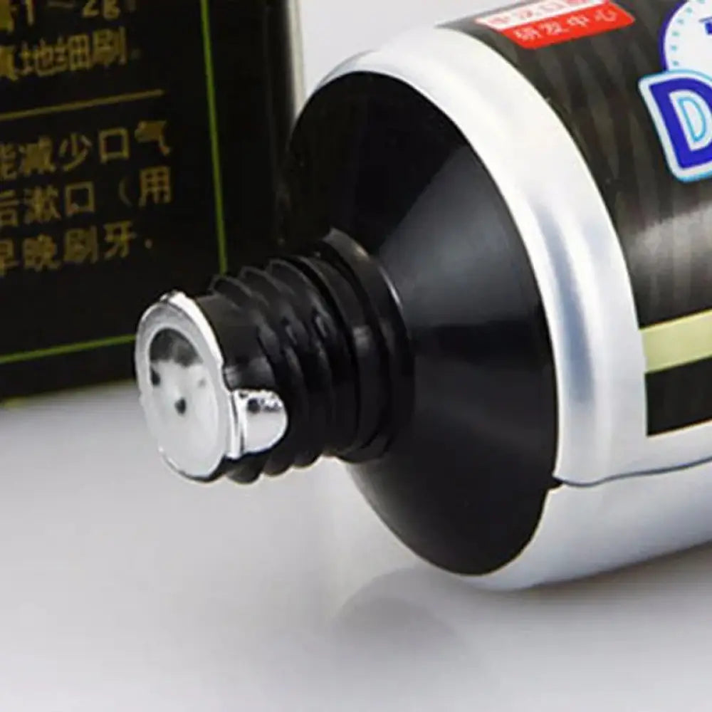 Black and silver bamboo charcoal whitening toothpaste tube with metallic cap for deep stain removal