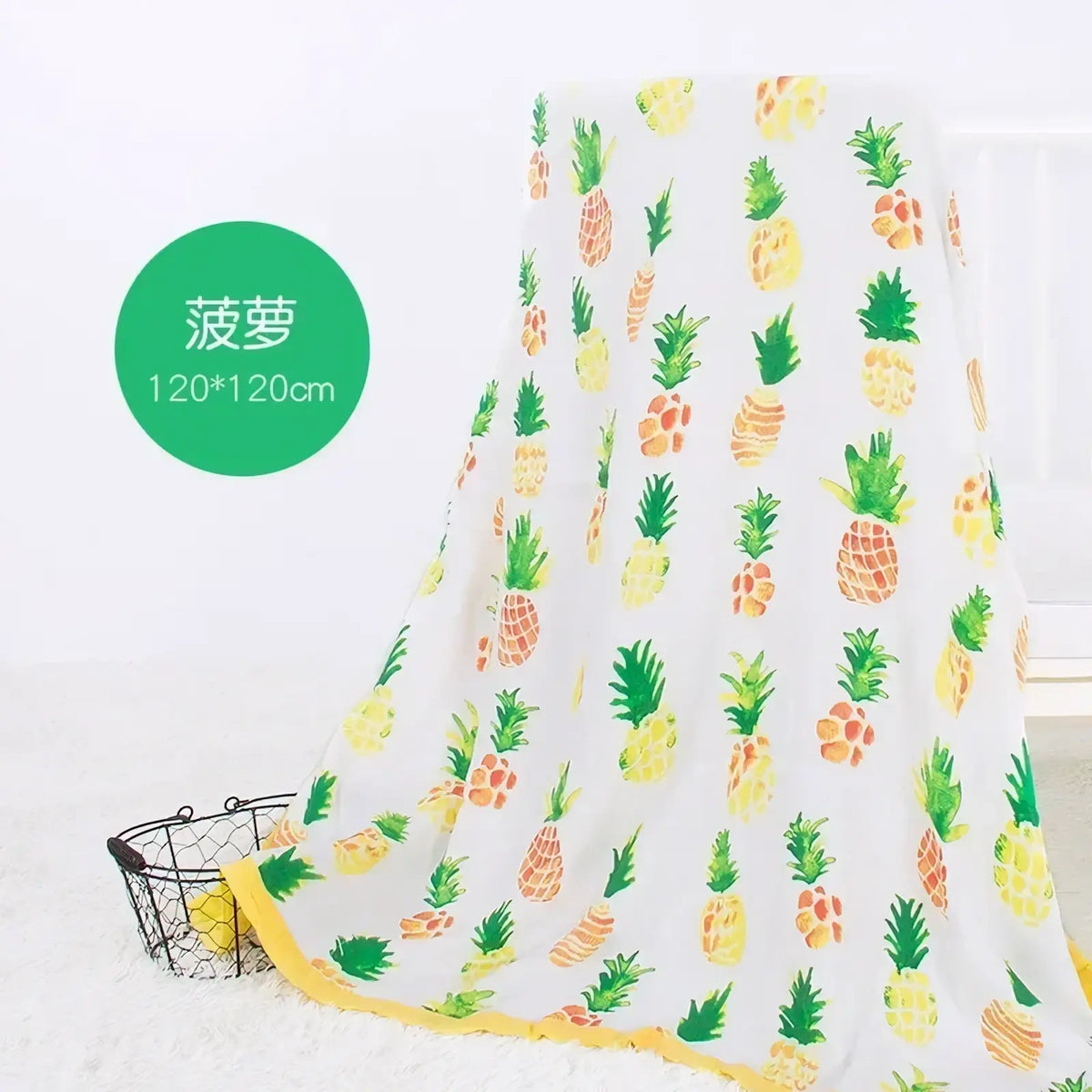 Bamboo cotton floral baby swaddle blanket with a white base, playful yellow and green pineapple pattern, and bright yellow border