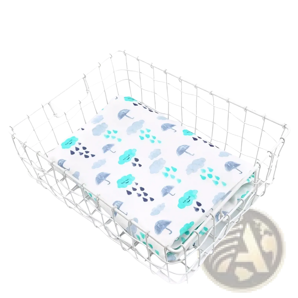 Bamboo cotton floral baby swaddle blanket with white fabric and teal gray umbrella raindrop cloud pattern in silver basket