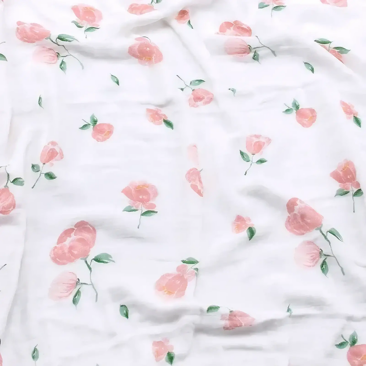 White bamboo cotton floral baby swaddle blanket with delicate pink roses and green leaves pattern on fabric