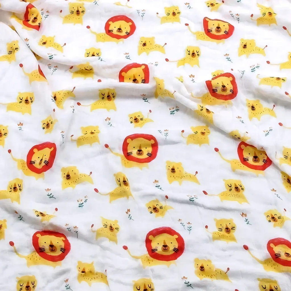 White cotton muslin bamboo cotton floral baby swaddle blanket with yellow lions and red manes playful pattern