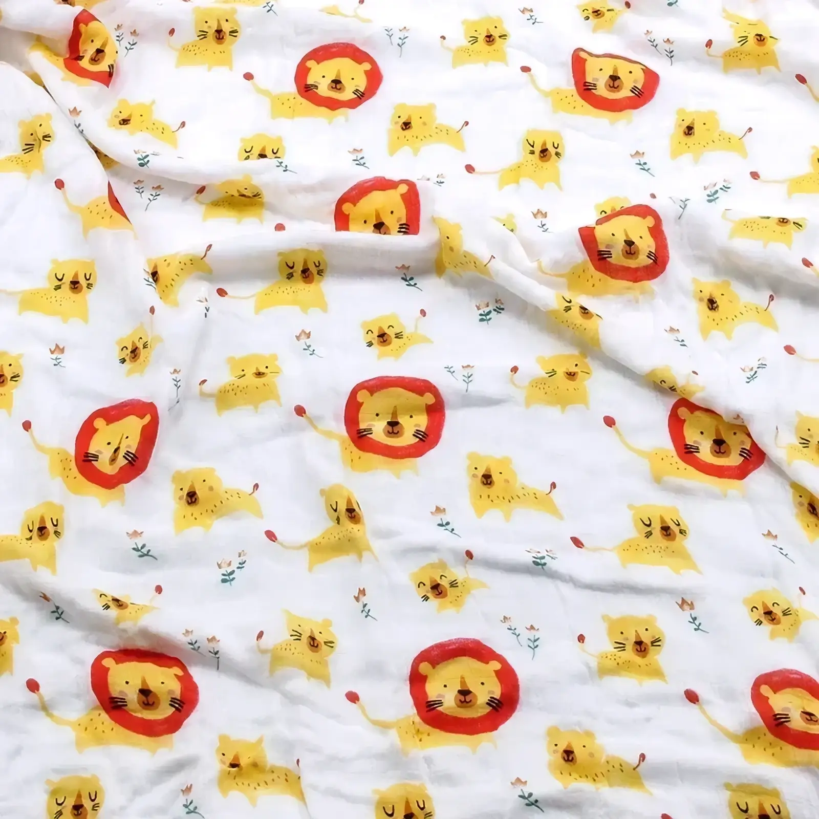 White cotton muslin bamboo cotton floral baby swaddle blanket with yellow lions and red manes playful pattern