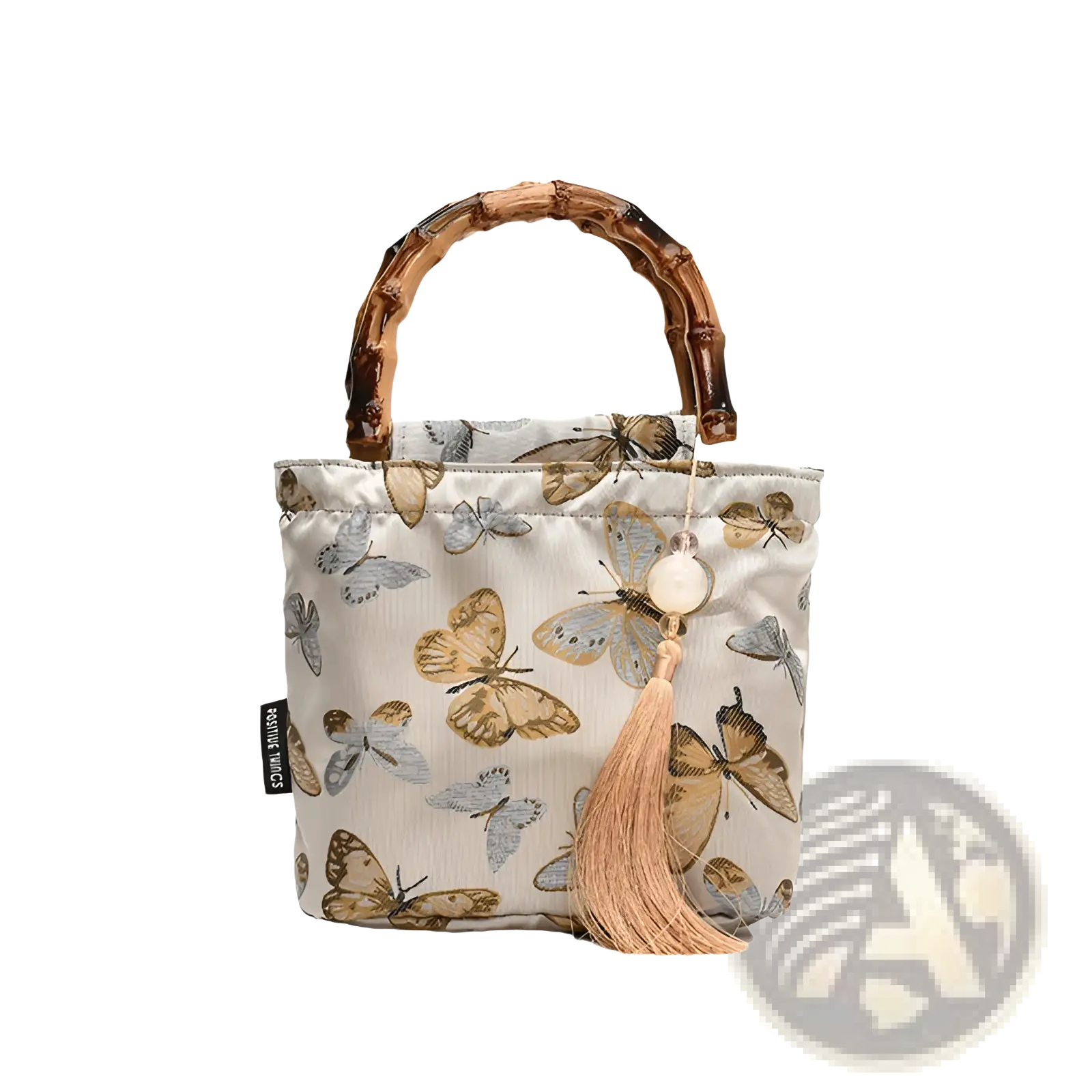 Beige fabric bamboo handbag with tassel and butterfly pattern in brown and gray on forest pattern canvas