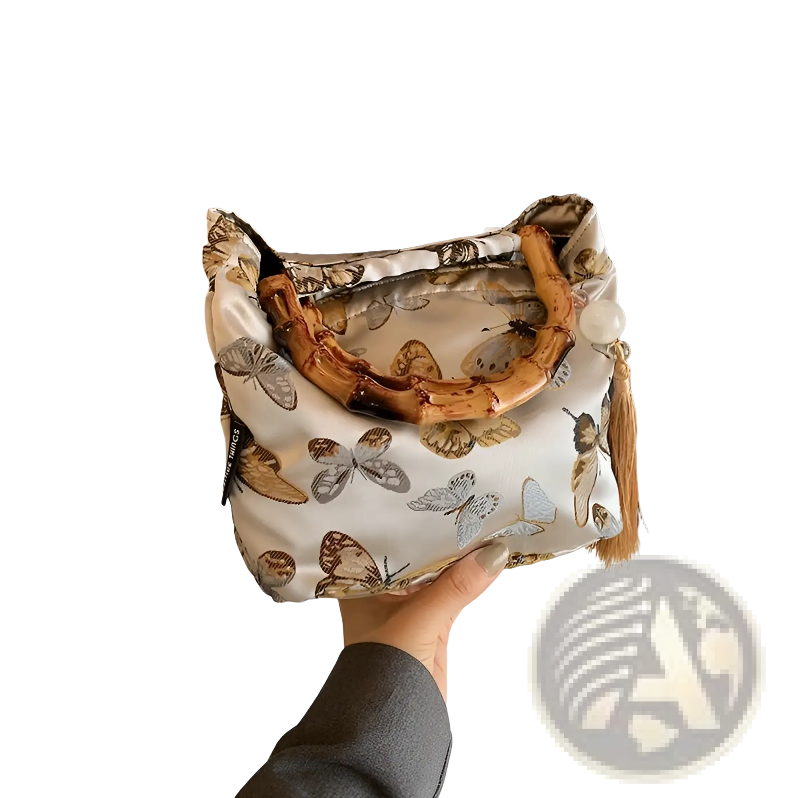A delicate white bamboo handbag with tassel detail and brown gray butterfly pattern on forest canvas material