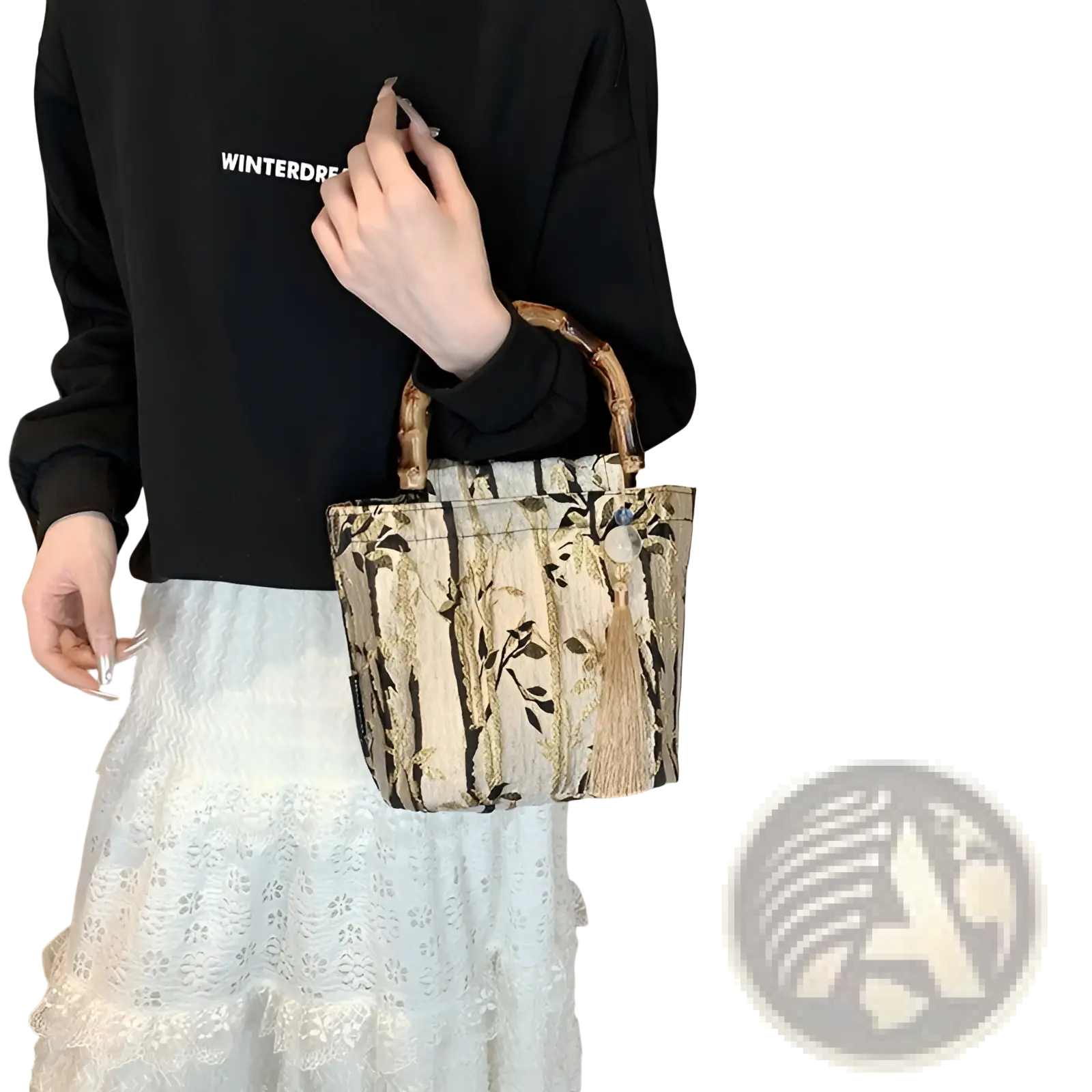 A stylish beige black and gold bamboo handbag with tassel and forest pattern canvas and bamboo handles