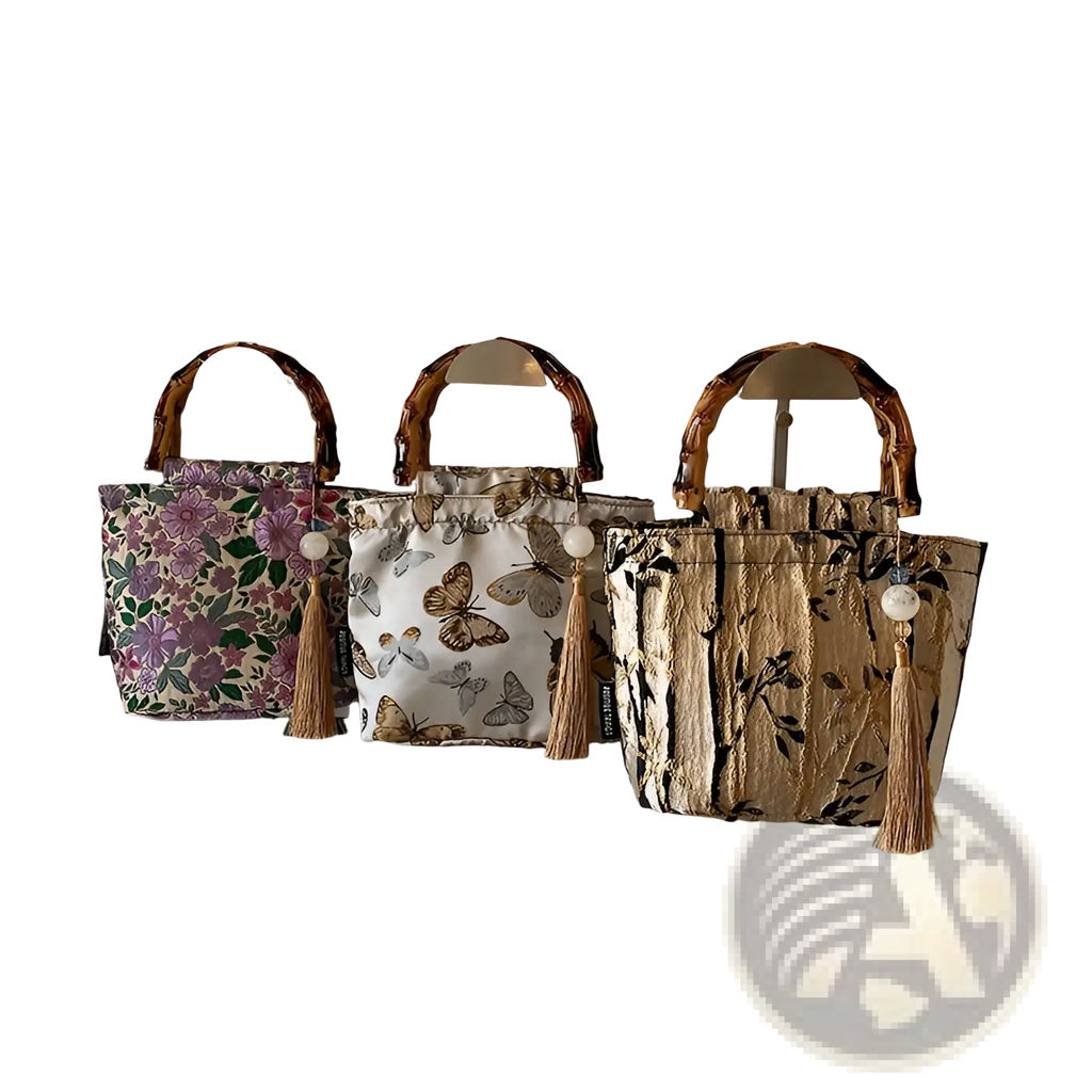 Three bamboo handbags with tassel accents featuring floral butterfly and leaf forest pattern canvas designs
