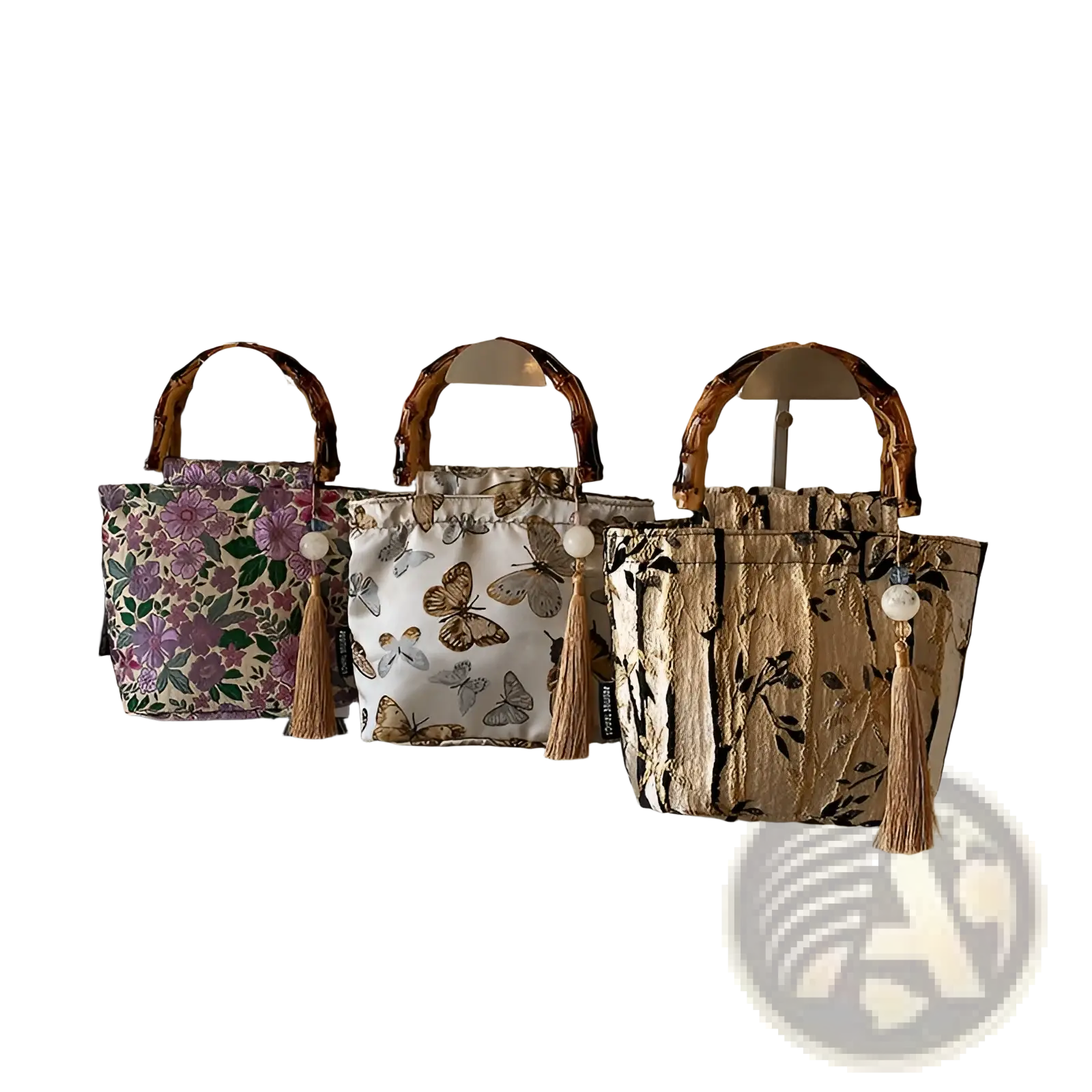Three bamboo handbags with tassel accents featuring floral butterfly and leaf forest pattern canvas designs