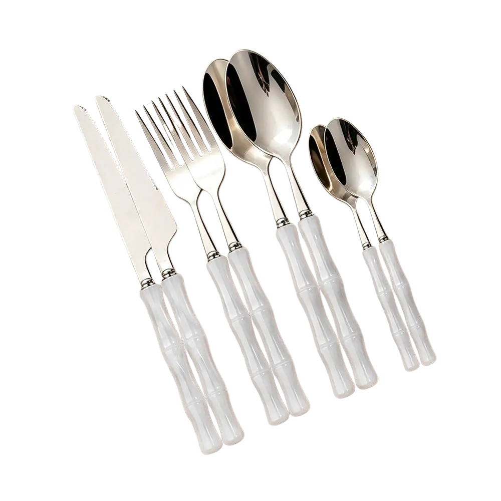 Elegant white bamboo handle stainless steel flatware set with polished blades and spoons for dining use