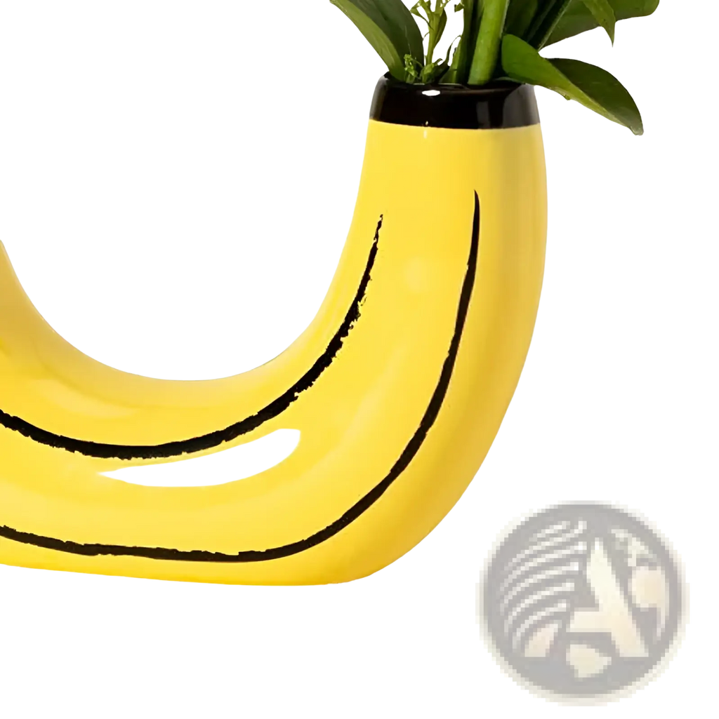 A bright yellow ceramic banana-shaped vase with black curved lines and glossy finish holding green foliage