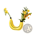 Bright yellow banana ceramic vase with black curved lines and glossy finish for fruit shaped home decor
