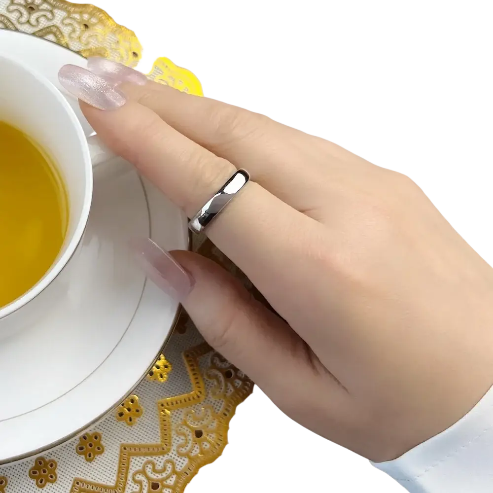A sleek silver 925 sterling silver band ring classic with a modern geometric minimalist design adorns the finger