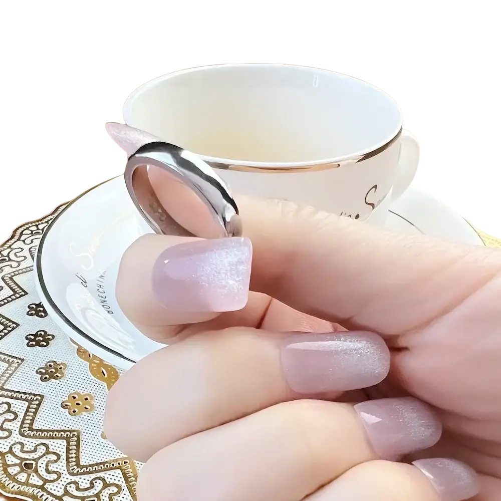 A sleek silver 925 sterling silver band ring classic with a polished minimalist design held by lavender glitter nails