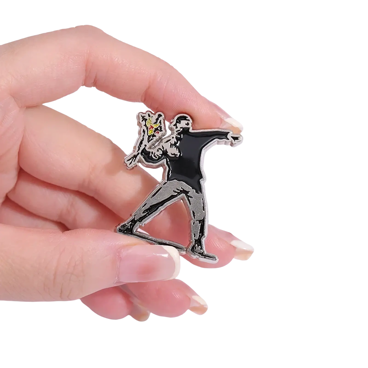 Black and silver enamel pin featuring a stylized figure holding a yellow spray can from Banksy street art badge