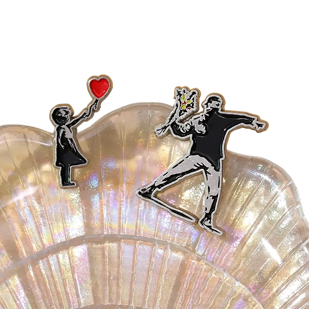 Banksy enamel pin street art brooch badge set featuring child with red heart balloon and figure throwing flowers in silver and color accents