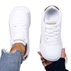 White leather barefoot walking shoes for women with gold accents and fashion branding on the tongue in a minimalist design