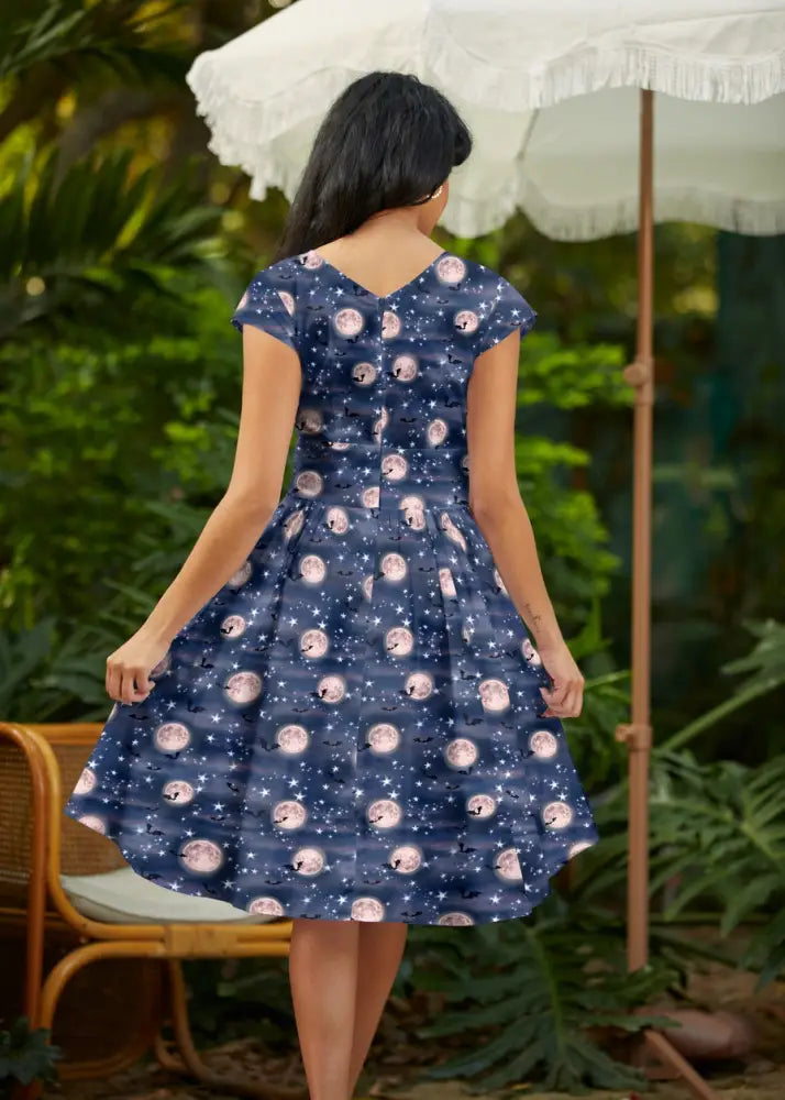 A navy blue vintage cotton wrap a-line dress with short sleeves v-neck and pink white moon phase pattern