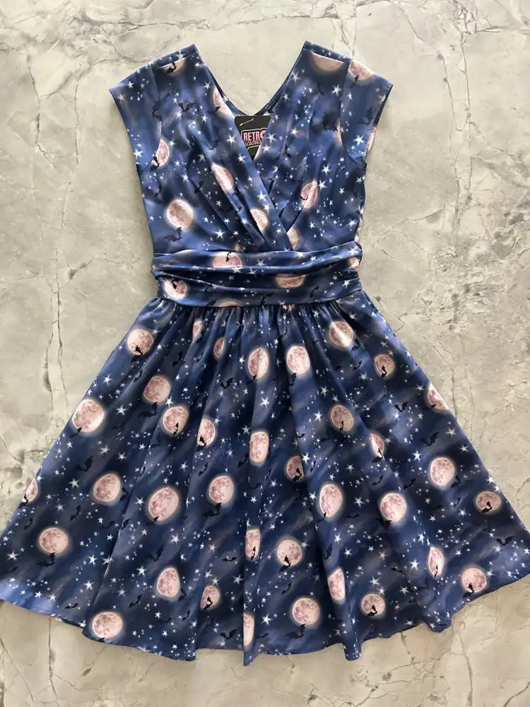 A navy blue vintage cotton wrap dress with v-neckline and bat moon pattern on satin-like fabric