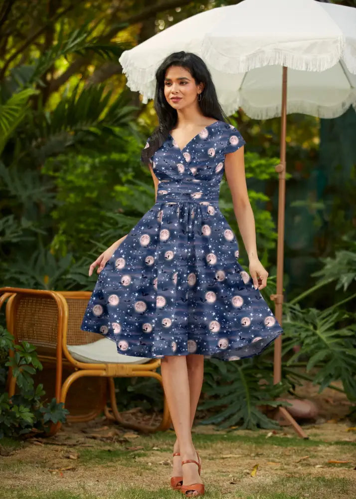 A navy blue vintage cotton wrap dress with v-neck, short sleeves, and pink flamingo print by Bat Moon Greta