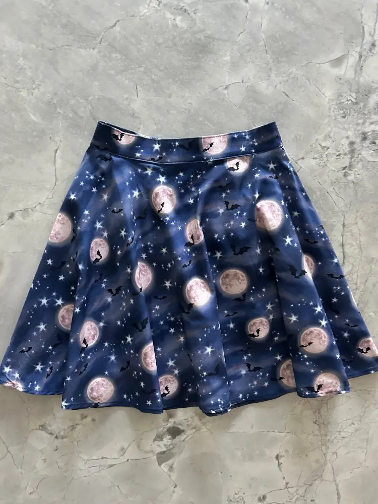 Navy bat and moon celestial pleated skater skirt in navy blue with pink moons black bats and white stars pattern