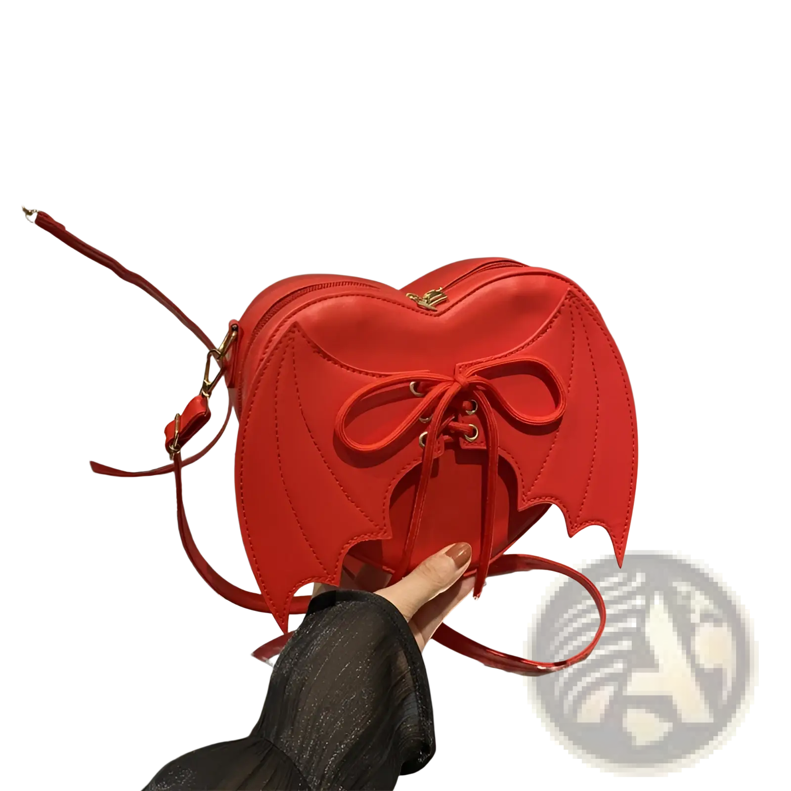 A vibrant red leather bat wing heart crossbody bag with lace up front detail and unique wing accents