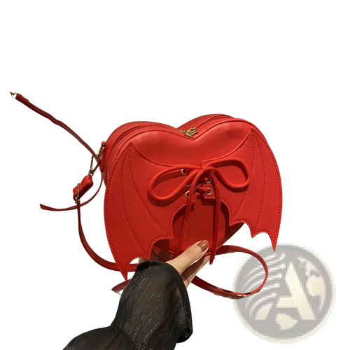 A vibrant red leather bat wing heart crossbody bag with lace up front detail and unique wing accents