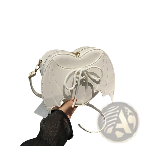 White bat-wing shaped crossbody bag with gold-tone hardware and white lace-up front detail in leather material