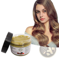 A clear glass jar with black lid contains golden-yellow batana oil hair mask sourced from Honduras natural formula