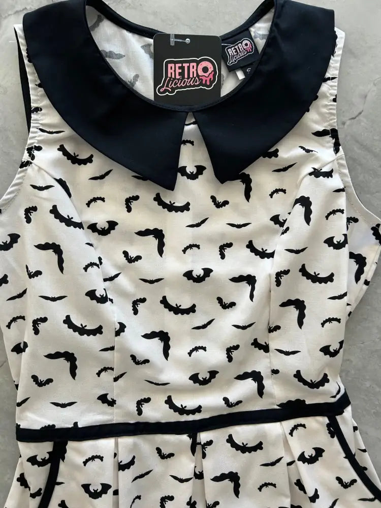 White sleeveless cotton a line dress with black bat prints and navy blue peter pan collar retro style