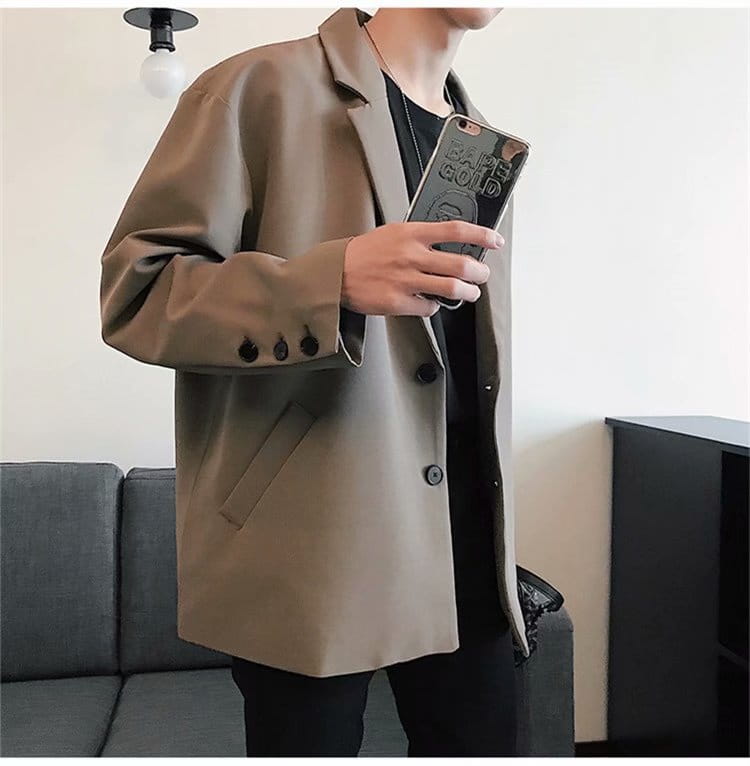Beige double-breasted loose casual thin suit jacket for men with dark brown buttons and a sleek modern cut.