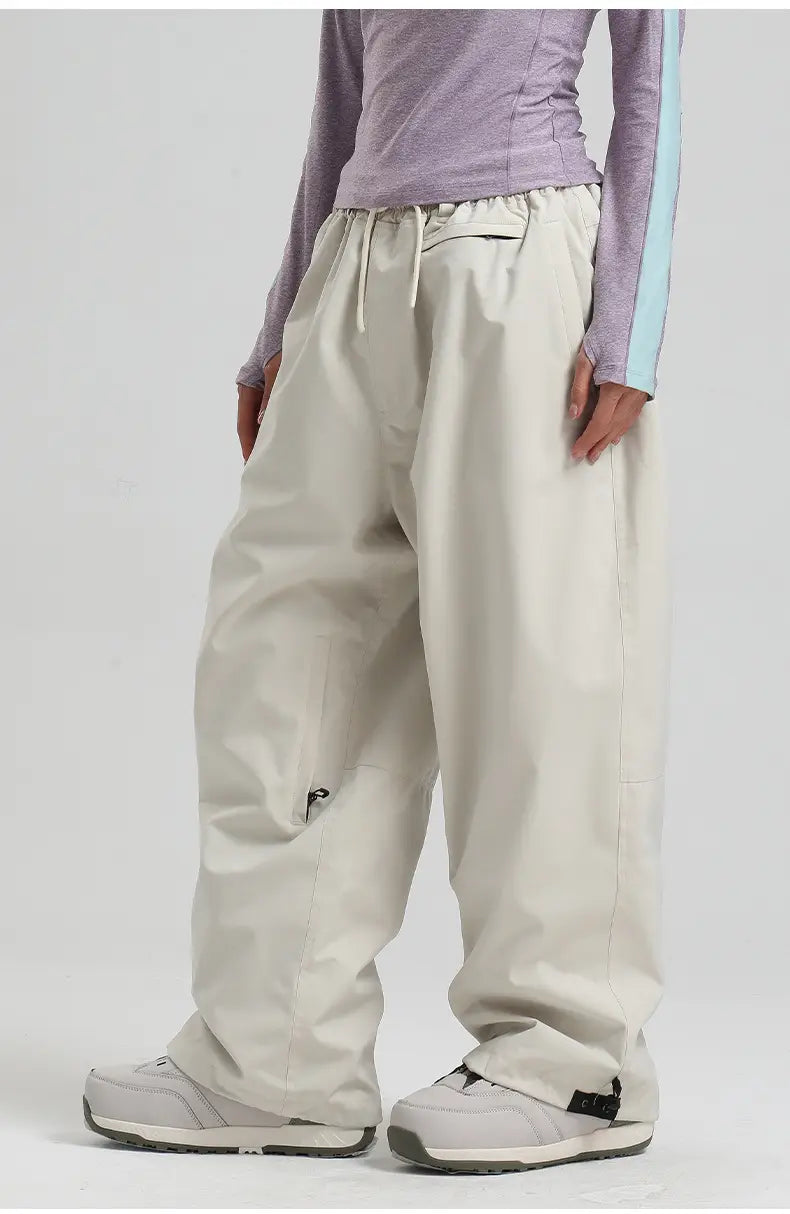 Beige waterproof windproof snow pants with a drawstring waist and subtle side pockets featuring a sleek modern design ideal for winter sports.