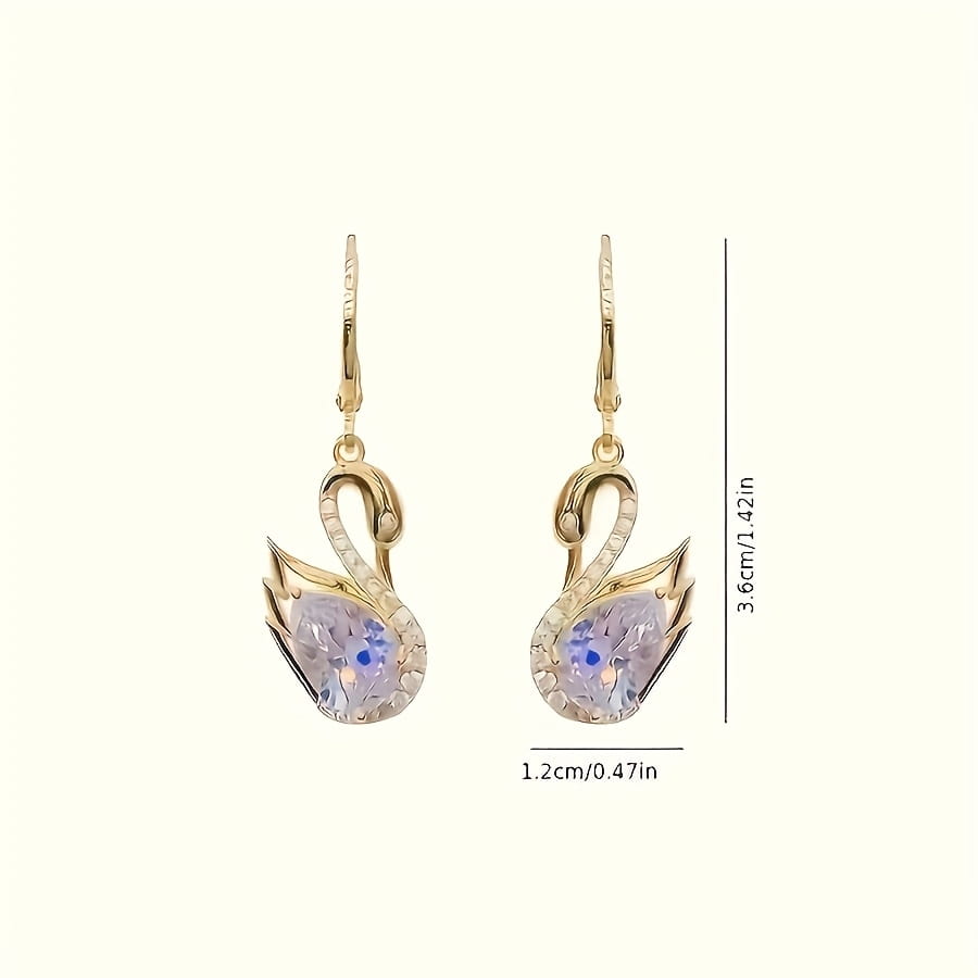 Gold-toned swan-shaped drop earrings for women featuring a central lavender crystal with a blue accent stone and smaller clear crystals along the wings.
