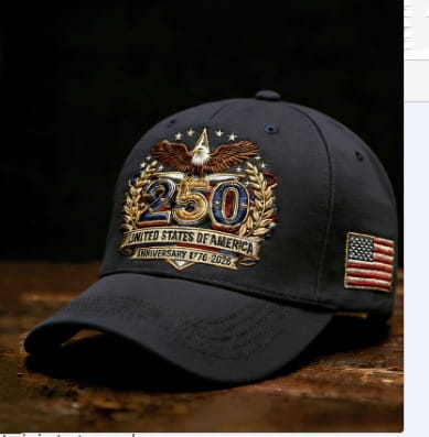 Dark gray baseball cap featuring an embroidered eagle with outstretched wings, the number 250 in gold and blue thread surrounded by laurel wreaths, and a small American flag patch on the side, commemorating the USA 250th anniversary.