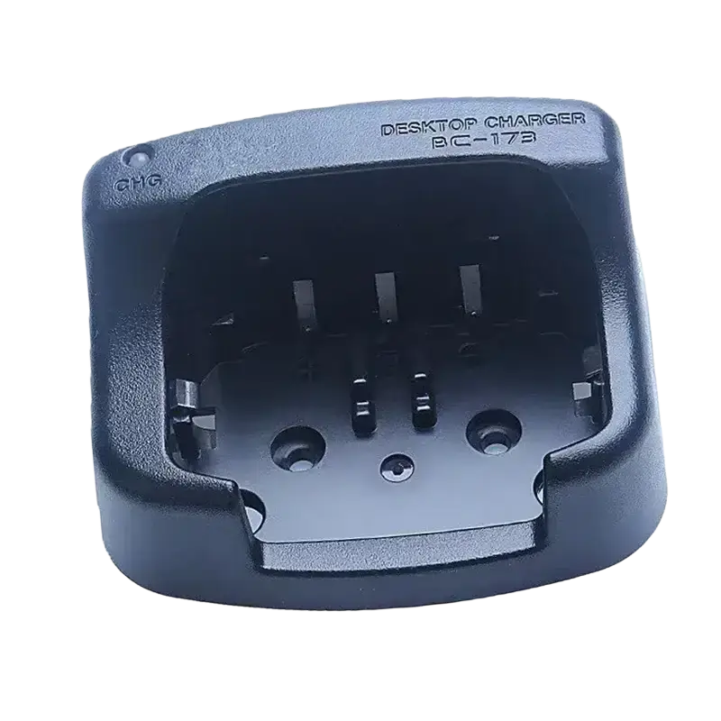 Black plastic bc-173 desktop charger with recessed cradle and molded text for icom radios and icom two-way radios