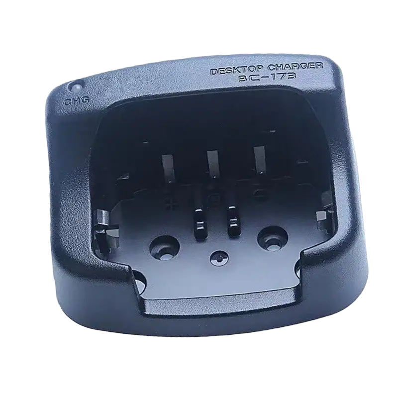 Black plastic bc-173 desktop charger for Icom radios showing the back side of the device
