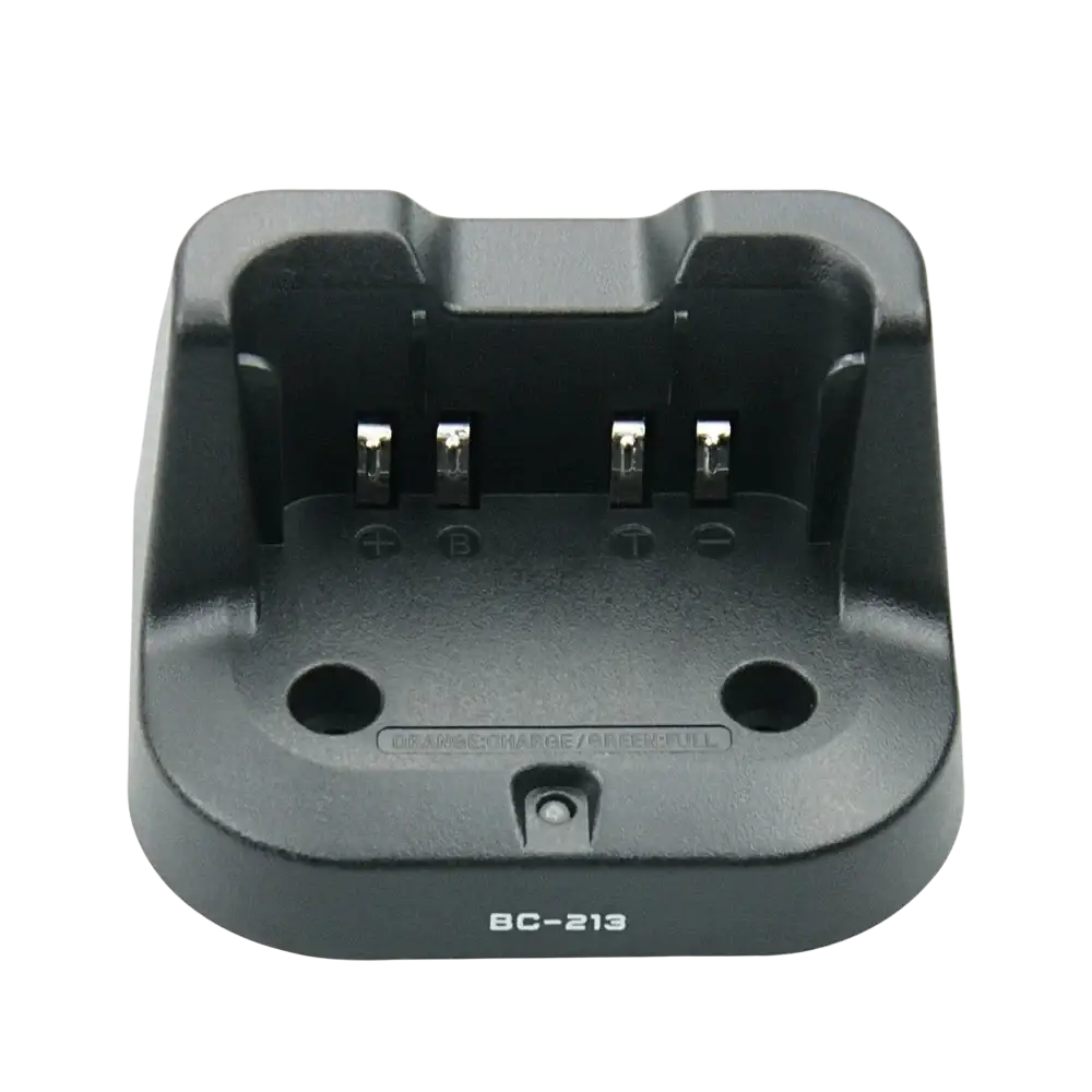 Bc-213 desktop charger for Icom radios black plastic with four metallic contacts and two circular holes visible