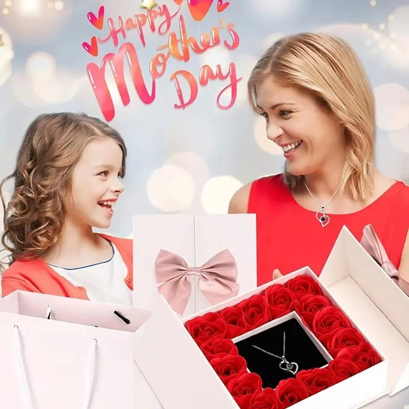 A heart-shaped silver projection necklace nestled in a black velvet box surrounded by vibrant red artificial roses in a rose gift box set.