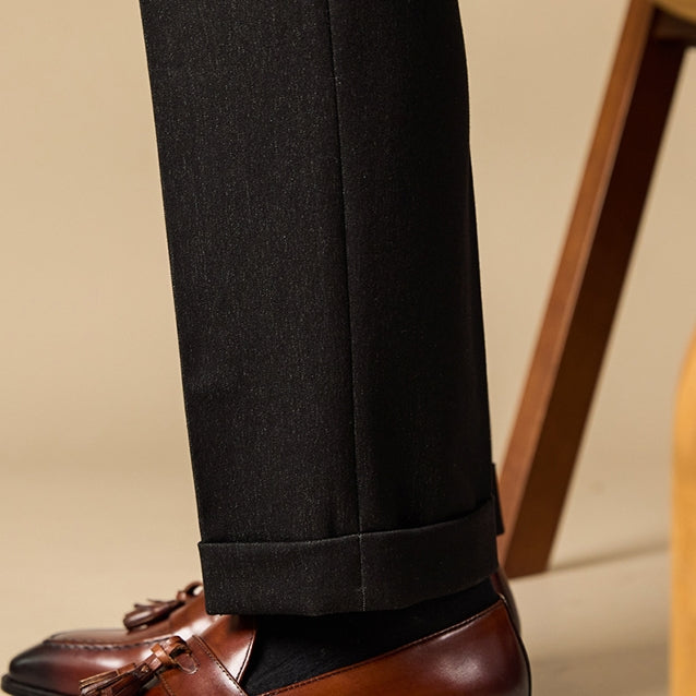 Black tailored trousers with subtle texture and cuffed hem paired with polished genuine leather brown tassel loafers