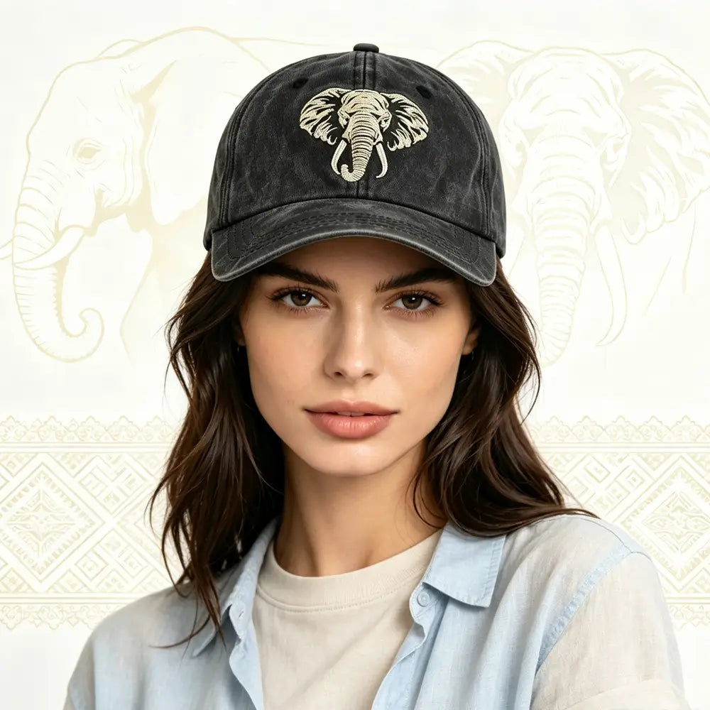 Black distressed baseball cap made of vintage washed cotton featuring a cream embroidered elephant design.
