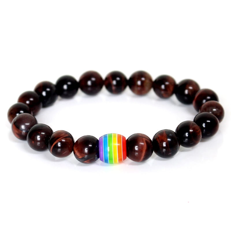 A beaded natural stone bracelet with dark brown tiger eye stones and a single rainbow-striped pride accent bead.