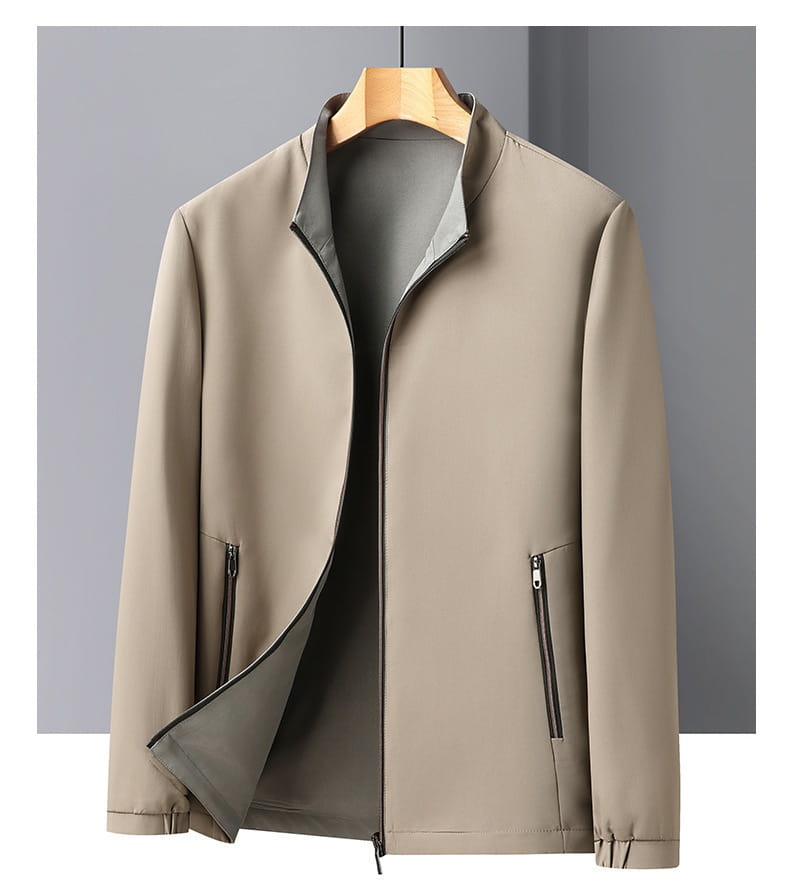 Men casual business stand collar jacket in beige lightweight fabric with subtle contrast inner lining and zippered pockets.
