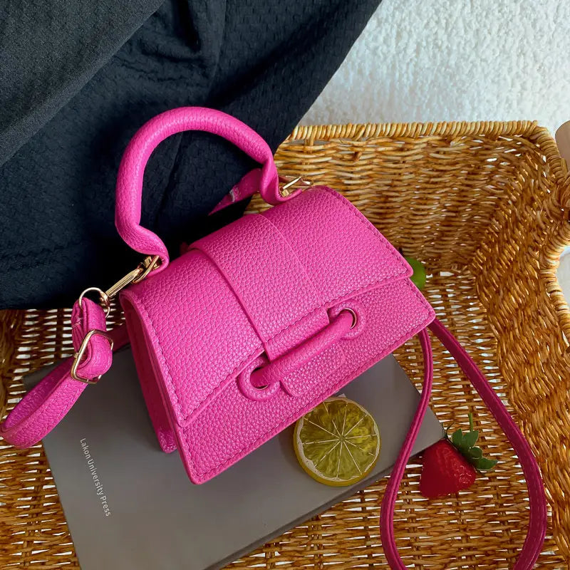 Leuchtend pinke Ketten-Umhängetasche Mini aus Kunstleder mit strukturierter Oberfläche, goldfarbenen Beschlägen und abnehmbarem Riemen.