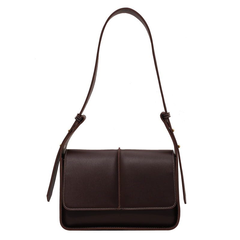 Dark brown leather crossbody bag with a minimalist design and adjustable strap for shoulder use.