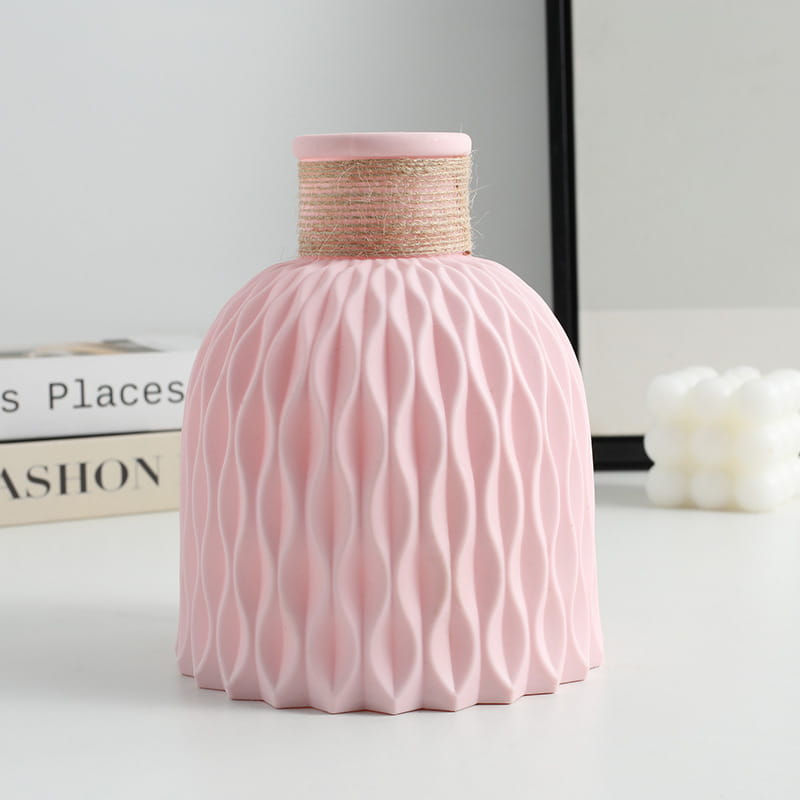 Pink ceramic vase with a textured wavy pattern and a natural twine-wrapped neck from a ceramic vase set with twine and wavy texture 4 pack.