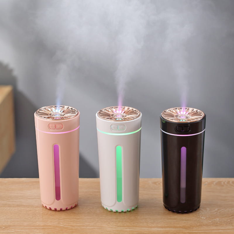 three cylindrical usb-powered phantom cup humidifier silent usb air diffuser in pastel pink white and dark brown with rose gold tops emitting mist and glowing led lights along their sides