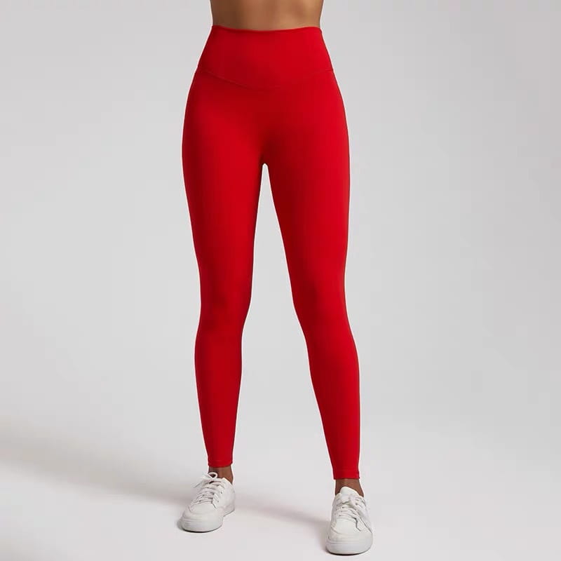 Bright red high waisted stretch fitted leggings made of stretchy form fitting fabric designed for comfortable wear.