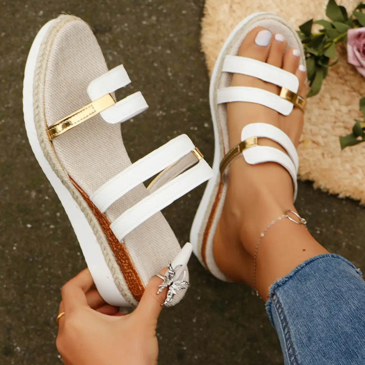 White wedge sandals with espadrille rope sole and gold-tone metal accents on platform straps